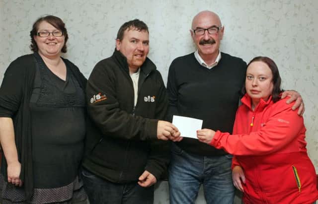 HE CAN. Liam Beckett, presents a cheque to Linda McKendry, Christopher and Laura-Anne from Can Can/Best Buddies on Tuesday night at Riada House.INBM10-16 006SC.