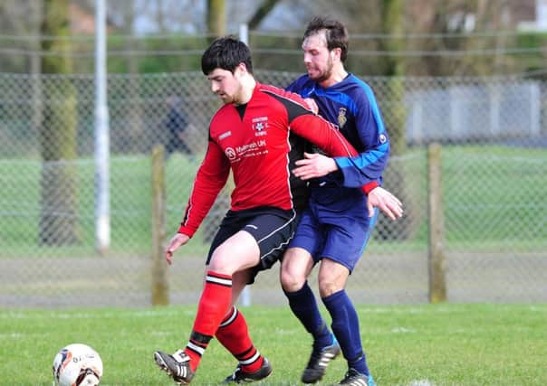 Cookstown RBL's James Dunne puts pressure on a Cookstown Olympic defender during Saturday's derby clash at Beechway.INMM0816-345
