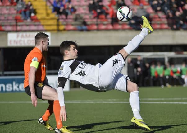 Carrick's Aaron Harmon in action with Crusaders' Dairmuid O'Carroll in the Tennent's Irish Cup quarter-final at Seaview. Photo: Presseye