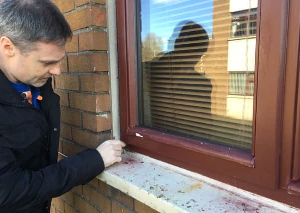 Paul Frew inspects the painted PVC window frame