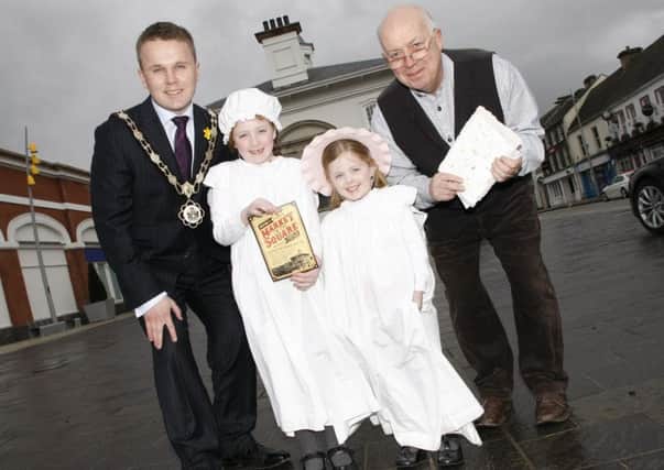 Mayor of Antrim and Newtownabbey, Councillor Thomas Hogg launches Antrims Market in the Square with Bethany and Isabella Douglas and Bill McBride, Paper Maker from Pogues Entry.