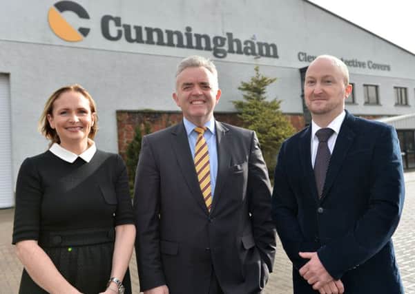 Enterprise, Trade and Investment Minister Jonathan Bell with David Cunningham and Briege Cunningham.
