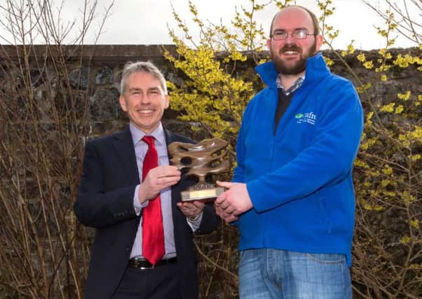 Francis Mulholland from Toome, a second year Foundation Degree horticulture student at CAFRE - Greenmount Campus is congratulated by Paul Mooney on winning the Chartered  Institute of Horticulture  Young Horticulturist of the Year Ireland Regional Final.  Paul Mooney received the the Bog Oak Trophy  for the winning college on behalf of CAFRE.