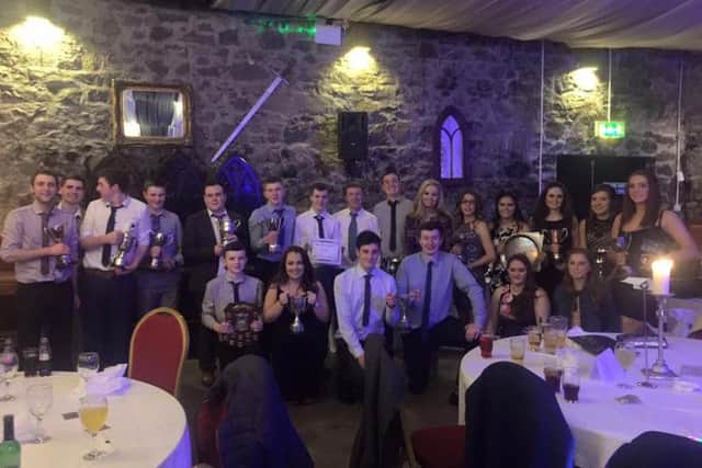 Prize winners who were in attendance at the 75th club dinner, showing off their silverware.