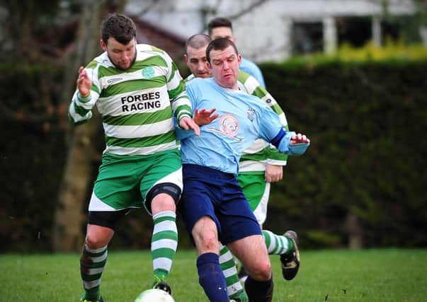 Cookstown Celtic's Stephen Devlin win's this midfield tussle during Saturday's league clash with Hillstreet  played at the Fairhill.INMM0516-390