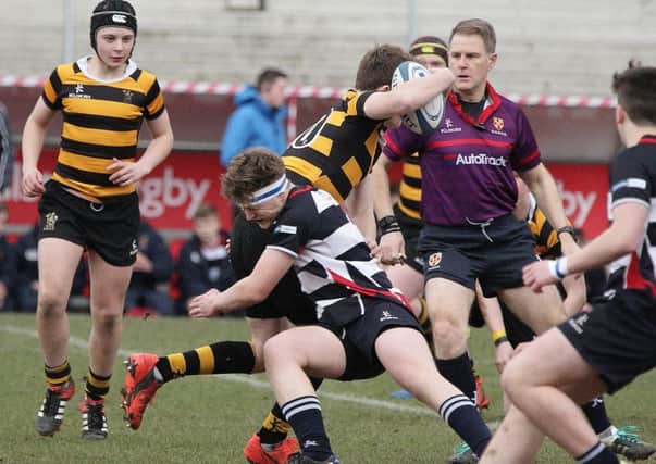 Neil Thompson stops RBAI captain Angus Adair in his tracks. Pic by Sm Smyth