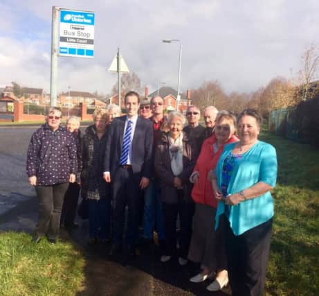 PAul Givan MLA at the bus stop beside Lillie Court off the Knockmore Road with residents of the area.