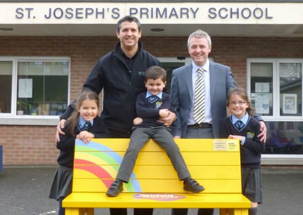 Philip McLorinan (Dunmurry Dental Practice) with his children Andrew, Kiera and Maria and Gavin Gallagher (Acting Principal) with school buddies
