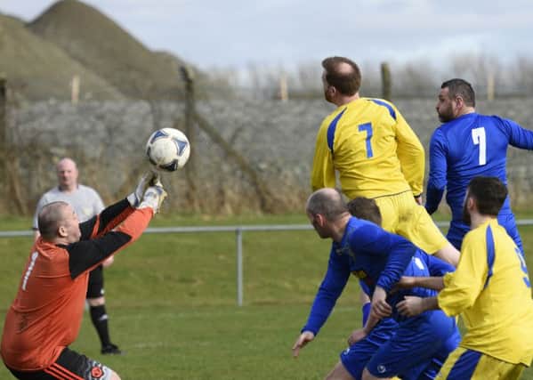 Churchill United keeper Paul Doherty fists the ball clear during Saturday's match against Eglinton. INLS1116-116KM