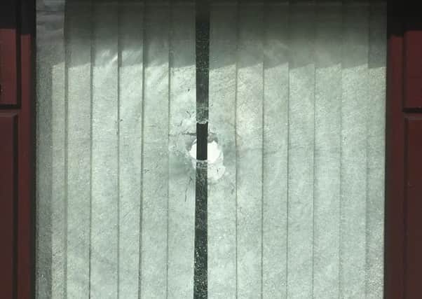 Bullet hole in window of Stewart Avenue home