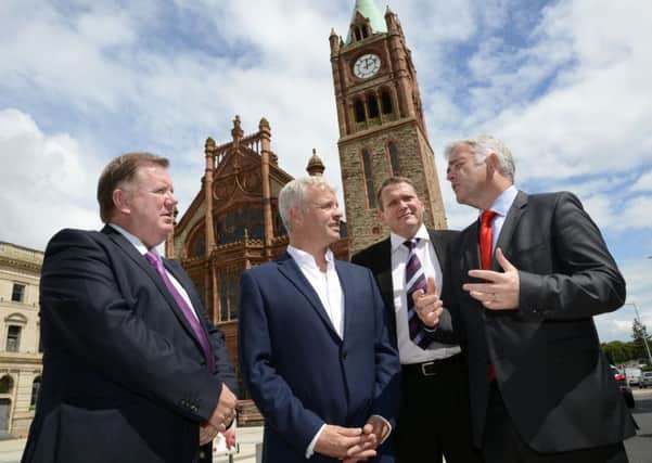 Enterprise, Trade and Investment Minister Jonathan Bell MLA, right, chatting to Bill Thompson, second from left, of One Source Virtual, at the jobs announcement in the Guildhall back in July 2015. Included are Bill Scott, left, and Derek Andrews, of Invest NI. DER2715-108KM