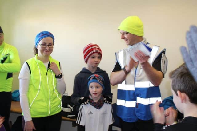 Mervyn Thompson leads the applause for wife Emer and sons Daniel and Rory on completing their 50th parkrun