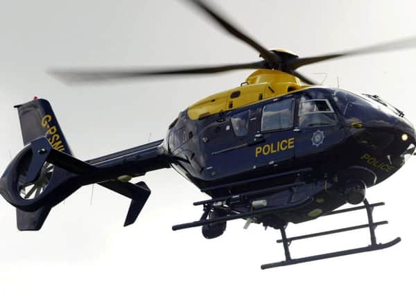 Police arrested a 23-year-old man after a laser was shone at a PSNI helicopter