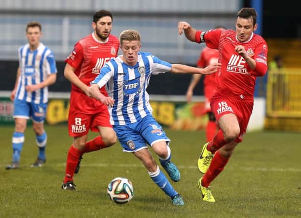 Coleraine's Lyndon Kane in action with Portadown's Michael Gault.