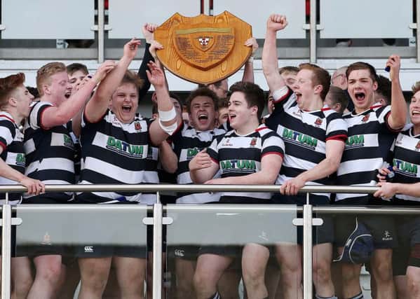 Wallace High School captain Jonny Stewart  lifts the Subsidiary Shield  after  a 21-5 victory over  Down High School   in the final