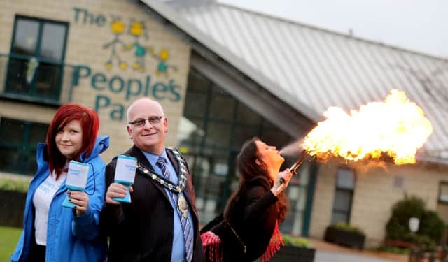 Mayor Billy Ashe with Laura Summerbell from the Alzheimer's Society and  fire breather Sophia Taylor. INLT-11-711-con.