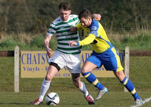 Lurgan Celtic's Josh Barton gets muscled off the ball by this Bangor FC player. INLM12-637AM