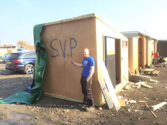 Volunteer Bryan McLean from Dunloy recently joined the Saint Vincent de Paul Northern Ireland's refugee aid mission to camps in Greece and France. He is pictured with one of the shelters that was being built with the help of SVP. INBM13-16S