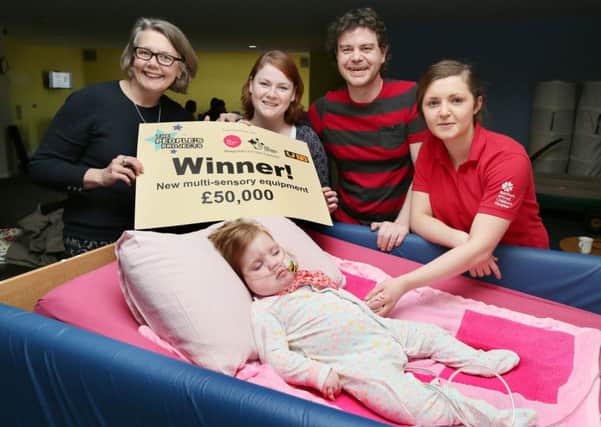 Big Lottery Fund's Joanne McDowell (left) with Laura McGurk and Shane Donaghy with their daughter Layla (19 months) and Northern Ireland Children's Hospice staff nurse Bethany Lucas (right). The family have been supported by the Children's Hospice, which has just won Â£50,000 in the People's Projects competition to make improvements to the multisensory room at Horizon House. INNT 12-504CON