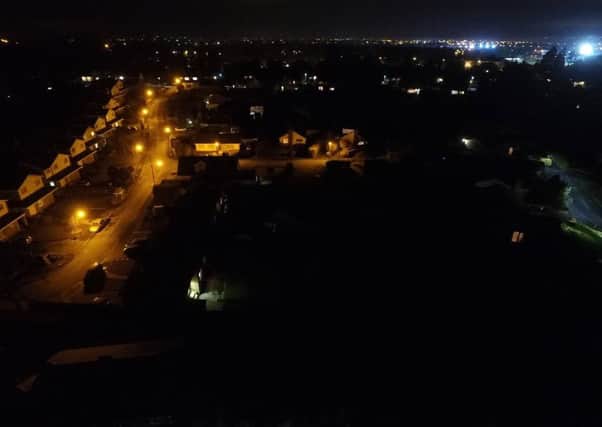 Stark contrast - an area with the old orange lights on the left and the new LED lights on the right.