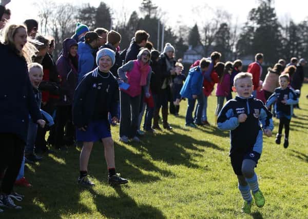 Matthew McDowell of Harryville BB  is cheered on by his mum as he comes home to win the Anchor Boys race at the Ballymena Boys Brigade Cross Country Championships at Ballymena Academy. INBT 10-190CS