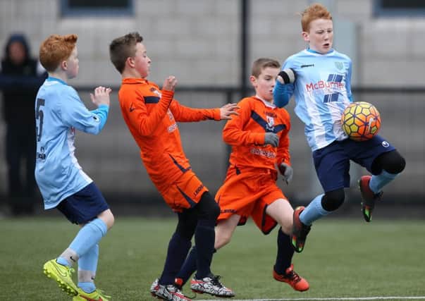 Ballymena's Michael Leetch in action while man of the match William Francey (5) looks on. INBT 12-184CS