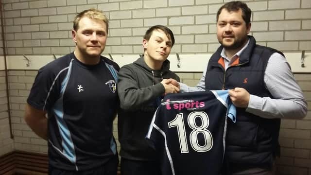 Justin McDaid from T-Sports in Coleraine presenting fourths players Jason Taggart and Ryan Brace with the Fourths new shirts prior to Saturday's cup semi-final against Ballnahinch. INBM13-16S