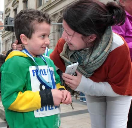 Little Evan McGrotty with his mammy, Louise, at the Walled City Marathon mini race in Guildhall Square last year. A funeral service will take place today. Picture Margaret McLaughlin
