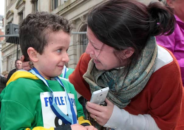 Little Evan McGrotty with his mammy, Louise, at the Walled City Marathon mini race in Guildhall Square last year. Picture Margaret McLaughlin