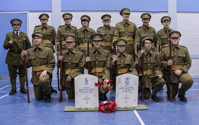 16th Newtownabbey BB Company Drill Squad dressed in 36th Ulster Division uniforms, with Lieutenant Paul Hamill (left). INNT 12-505CON