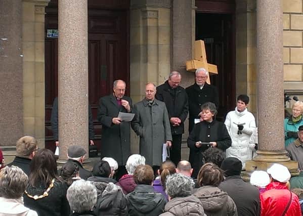 Those taking part in the Walk of Witness last year gather with the leaders of the four main Christian denominations at St Columb's Hall on Good Friday afternoon.