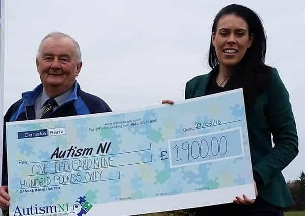 Dave Farley of Larne Golf Club hands over a cheque for Â£1,900 to Sarah Jane Cassells of Autism NI. INLT-13-706-con