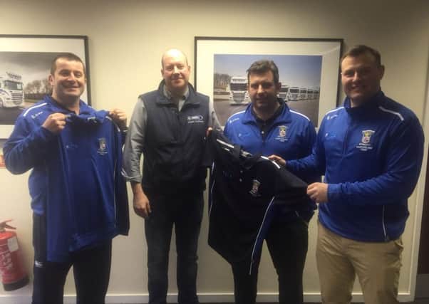 Patrick Derry from Derry Transport presents tour kit to Peter Keightley from Portadown over 35s. Included are Simon May and Geoff Caldwell