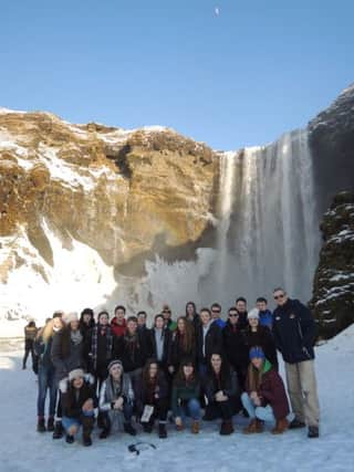 Friends pupils enjoy a waterfall during their trip to a very scenic Iceland.