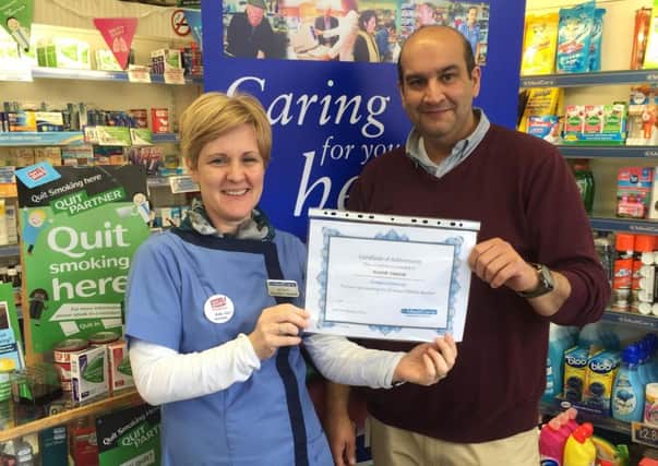 Sudhir Tandon receives his certificate from Jenny Todd of Hannon's Pharmacy. INNT 12-805CON