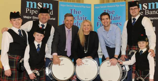 South Antrim MLA Paul Girvan and his wife Alderman Mandy Girvan and their son Councillor Tim Girvan pictured at the drums they each sponsored on behalf of The Sinclair Funders. The Girvan family helped launch The Sinclair Funders fundraising initiative with a generous family donation of Â£200. Also included are MSM Pipe Band members John Fittis (Pipe Major), Matthew Shaw (Drum Sergeant), Oliver McIlwaine, Zach McCauley and Evie McKeown. INNT 13-504CON Pic by John Kelly