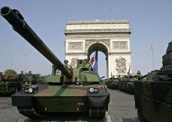 "Leclerc" tanks drive down the Champs Elysees avenue during the Bastille Day military parade, Friday July 14, 2006 in Paris. (AP Photo/Francois Mori)