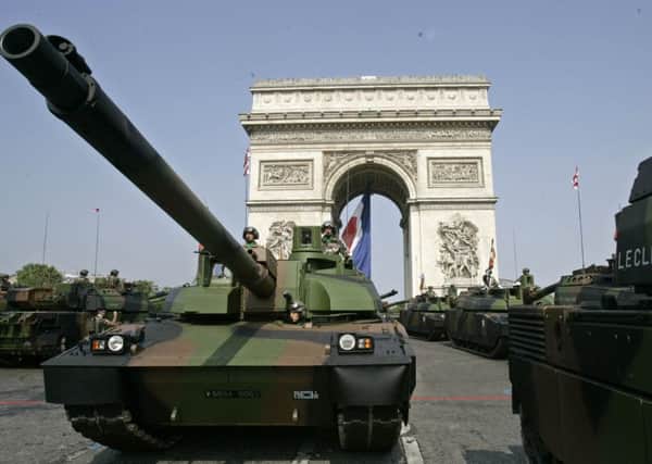"Leclerc" tanks drive down the Champs Elysees avenue  during the Bastille Day military parade, Friday July 14, 2006 in Paris. (AP Photo/Francois Mori)