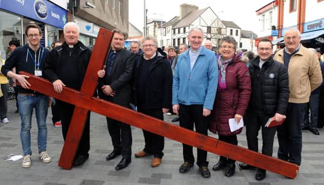 At the cross:
Lisburn City Centre Clergy pictured at the cross prior to the annual Good Friday carrying of the cross walk of witness in Lisburn.  L to R:  Rev Simon Genoe (Vicar at Lisburn Cathedral), Father Dermot McCaughan (P.P. of St Patricks Church, Rev John Brackenridge (First Lisburn Presbyterian Church), Rev Mervyn Ewing (Seymour Street Methodist Church), The Very Rev Canon Sam Wright (Lisburn Cathedral), Evelyn Whyte (Deaconess at First Lisburn Presbyterian Church), Rev Paul Dundas (Christ Church Parish) and George Hilary (Lisburn Christian Fellowship).