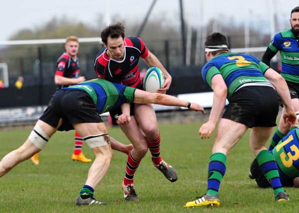 Rainey's Gavin Martin is tackled by a Seapoint player during Saturday's AIL clash at Hatrick Park.INMM1416-321
