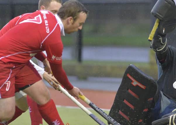 Mandatory Credit:  Rowland White / PressEye
Men's Hockey: EY Irish Hockey League
Teams: Lisnagarvey (blue) v Cookstown (red)
Venue: Lisnagarvey
Date: 14th November 2015
Caption: Cookstown goalkeeper, Ian Hughes was successful in taking the ball from Timmy Cockram, Lianagarvey