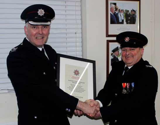 Noel McCurdy Crew Commander Rathlin Island Fire service retire after 26 years service he is receing his certificate from Area Commander Paul Coyle. INBM15-16K