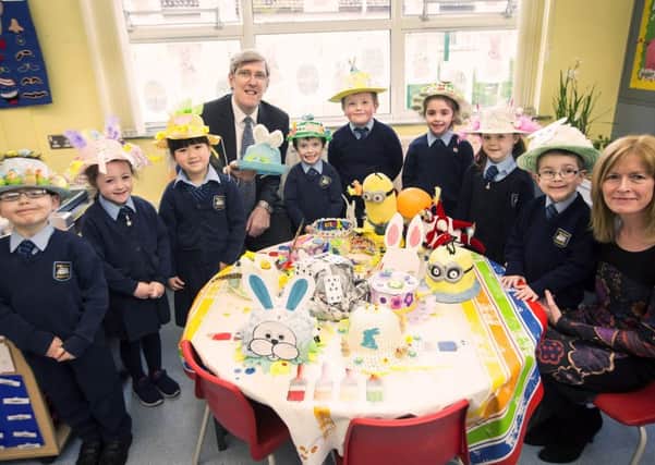 Education Minister John O'Dowd has visited St John's Primary School, Gilford.  During the visit the minister met with pupils and  saw their easter bonnets.  Pictured with  the minister are P1 pupils the School Principal, Catherine McCooe.