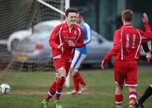 Ahoghill Thistle's Ryan Sand is congratulated by team mate Paul Aiken (11) after scoring his team's third goal from the penalty spot during Saturday's win over Abbeyview in Ahoghill. INBT 14-177CS
