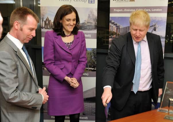 London Mayor Boris Johnson cuts the cake to celebrate Magherafelt company Windell's 30th birthday celebrations during Monday's visit to the factory. Looking on are Northern Ireland Secretary of State Theresa Villiers  and Ian Henry (Windell Director).INMM0916-341