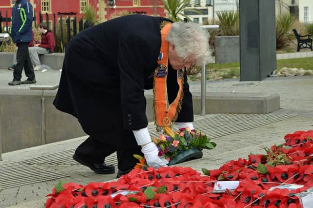 Harry Whiteside, Belfast Junior County Master lays a wreath at Carrick War Memorial. INCT 12-024-PSB