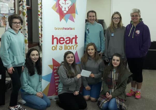 Clare (far right) from Bravehearts NI talks to the Cullybackey Senior Section about the charitys important work. Image submitted.