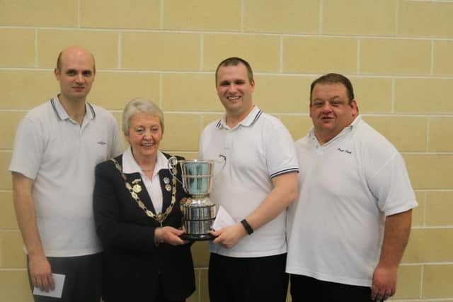 From left, Gordon Stubbs, Raymond Stubbs and Paul Reid receive the Irish Triples Cup from Flo McNally.