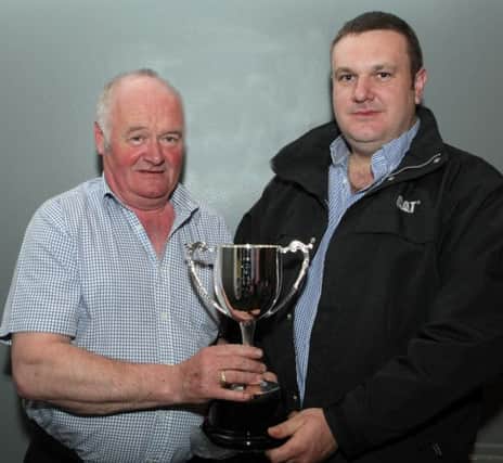 NEW. Ivan Lynn, who presented a new trophy to the Ballycastle & District Horse Ploughing Society, pictured handing it over to the inaugural winner, Hector Cassley on Friday night.INBM14-16 001SC.