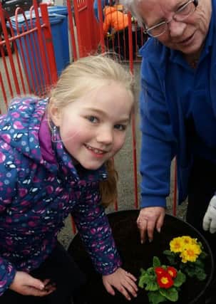 Carnlough Community Association volunteer Patricia McConnell and Megan get to grips with the planting at Carnlough Integrated Primary School. INLT-15-708-con